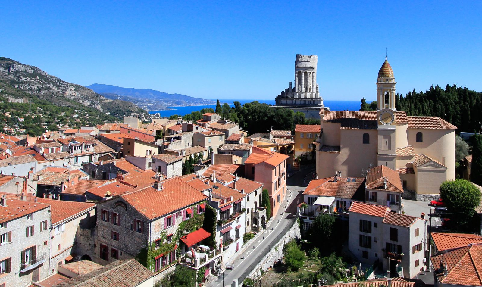 The rooftops of La Turbie with the Troph&eacute;e d'Auguste and the belltower of Saint-Michel above the Mediterranean coast